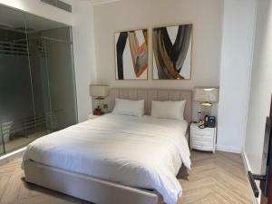 a bedroom with a large white bed and a mirror at Phuc Thang Boutique Seaview Hotel in Phu Quoc +13 photos