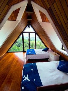 an attic room with two beds with an american flag on them at Mayday Mountain View in Alajuela City