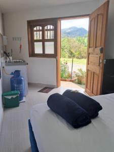 a bed with a blue pillow on top of it at jardin de flores Ant habitación 101 JW in Jardin