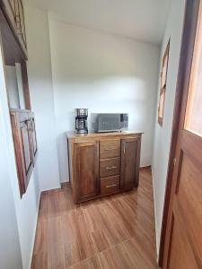 a kitchen with a microwave on a wooden cabinet at jardin de flores Ant Apto 201 JW in Jardin +2 photos