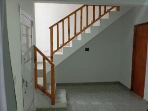 a staircase in a room with a wooden door at Duplex La Luna in Mar del Tuyú