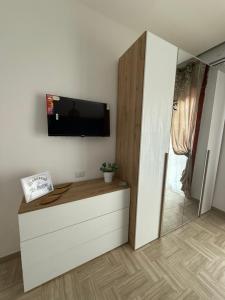 a living room with a flat screen tv on a wall at Home Capri in Torre del Greco