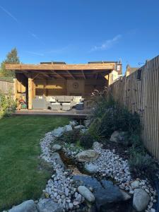 a backyard with a fence and a garden with a patio at High spec 4 bed Victorian house in Surbiton