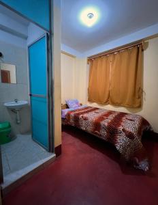 Ένα ή περισσότερα κρεβάτια σε δωμάτιο στο Curahuasi Backpackers