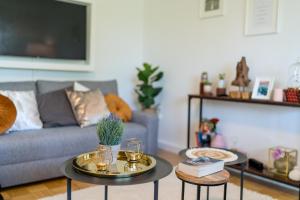a living room with two tables and a couch at OG2 L City Wohnung mit Balkon 15min bis Salzburg in Freilassing