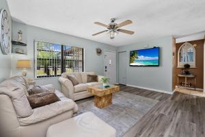 a living room with two couches and a ceiling fan at Crystal River Tropical Oasis Heated Pool-3 mins Sister Spring in Crystal River