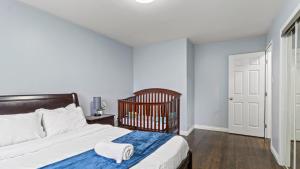 a bedroom with a bed and a crib in it at Family Home Near Toronto, Game Room, Backyard, Parking, Self-Checkin in Pickering