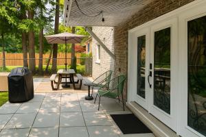a patio with a table and an umbrella at Family Home Near Toronto, Game Room, Backyard, Parking, Self-Checkin in Pickering