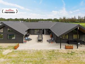 a house with a large patio in front of it at 20 person holiday home in Nørre Nebel in Nørre Nebel