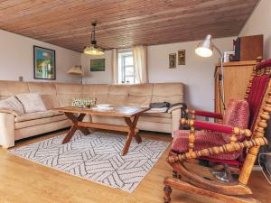 a living room with a couch and a table at 6 person holiday home in Vestervig in Vestervig