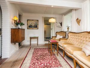 a living room with a couch and a rug at 4 person holiday home in Tønder in Tønder
