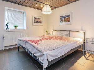 a bedroom with a large bed and a window at 6 person holiday home in Thisted in Thisted