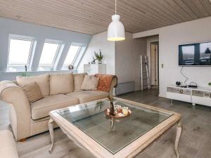 a living room with a couch and a coffee table at 6 person holiday home in Vestervig in Vestervig