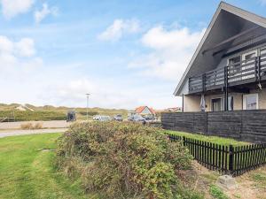 a house with a fence in front of it at 6 person holiday home in Vestervig in Vestervig
