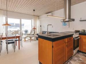 a kitchen with a sink and a dining room at 4 person holiday home in Vestervig-By Traum in Vestervig