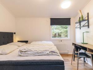 a bedroom with a bed and a desk with a computer at Spacious Retreat by Limfjorden - By Traum Ferienwohnungen in Sillerslev +40 photos