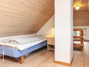 a bed in a room with a wooden ceiling at Panoramic View Fisherman's House - By Traum Ferienwohnungen in Vesløs