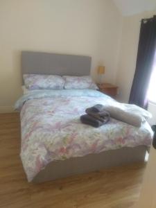 a bedroom with a bed with a floral bedspread at Barrow mews views in Carlow