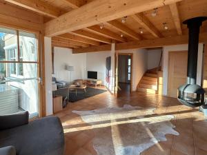 a living room with a wood ceiling and a fireplace at Landhaus St Georgen im Gailtal in Emmersdorf