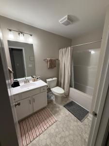 a bathroom with a sink and a toilet and a shower at Tide's Turn Retreat in Cedar Point +19 photos
