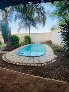 a small swimming pool in a backyard with a tree at Kingston House in La Rioja