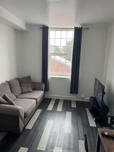 a living room with a couch and a window at One bed flat Northampton Town 5 in Northampton