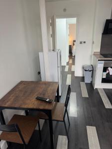 a kitchen with a table and chairs and a refrigerator at One bed flat Northampton Town 5 in Northampton