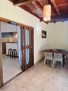 a room with a table and a wooden door at Flat Yemanjá beira-mar, 4 pessoas, quarto e sala, piscina in Marau +25 photos
