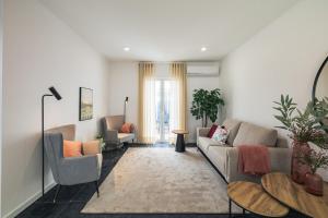 a living room with a couch and two chairs at Modern 3BR Home, AC in All Rooms, Walk to 2 Beaches, Private Patio, Washer & Dryer in Ribeira Grande +24 photos