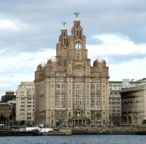 a large building with a clock tower on top of it at Stylish City Centre Stay with balcony - Near Football Stadiums in Liverpool