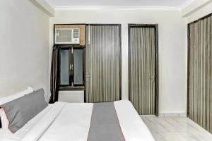 a bedroom with a bed with a air conditioner in it at Live on DEL2479 in New Delhi +20 photos