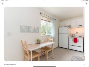a small kitchen with a table and a white refrigerator at Cozy, Charming & Central in Kent in Kent