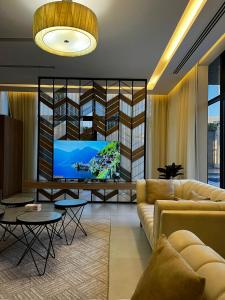 a living room with a couch and a flat screen tv at اليجنت فيلا in Buraydah