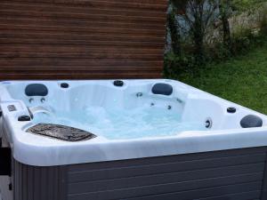 a large white bath tub sitting in a yard at Holiday Home Stara Murva - Three Bedroom Holiday Home with Patio in Tuheljske Toplice
