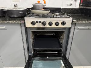 an oven with a pot sitting on top of it at Departamento en Zona Norte A ESTRENAR con hermosa vista in Salta +17 photos