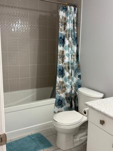 a bathroom with a toilet and a shower curtain at One Bet room in Whitby
