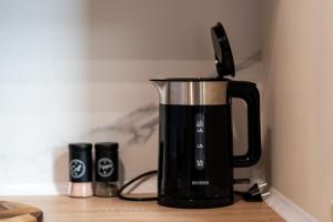 a black coffee maker sitting on a counter at Rajska7712 in Wrocław