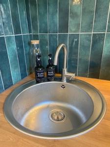 a sink with two bottles on top of it at Studio Premium Haguenau in Haguenau +26 photos