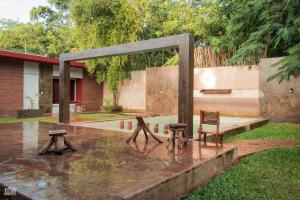 a park with a bench and chairs in the rain at TUUK Hotel Raíces in Valladolid