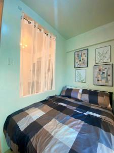 a bedroom with a large bed in a room at Cozy Cabin by JLS Near Venice Grand Canal Mall in Manila