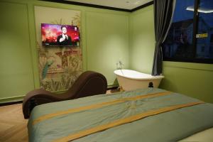 TV a/nebo společenská místnost v ubytování L'amant Hotel - Cần Thơ + 19 fotografií