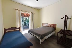 Ένα ή περισσότερα κρεβάτια σε δωμάτιο στο Chácara Morretes Arraial +131 φωτογραφίες