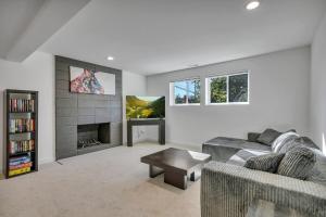 a living room with a couch and a fireplace at Stylish Bellevue Retreat in Bellevue