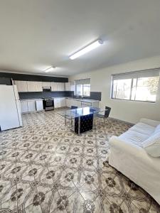 a bedroom with a bed and a table in a room at Spacious Queen Room in Comfortable Two Story House - L2 