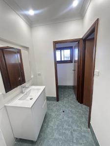 a bathroom with a sink and a mirror at Spacious Queen Room in Comfortable Two Story House - L2 