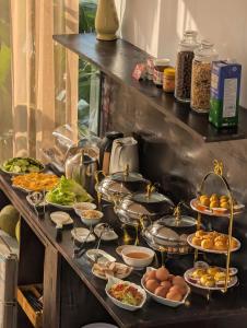 a buffet with many plates of food on a table at Maison Maravelle Hotel - Boutique Stay in Hanoi Old Quarter in Hanoi