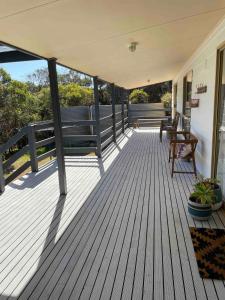 a wooden deck with a bench on a house at Southside at Vivonne in Vivonne Bay