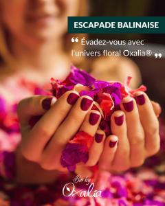 a woman is holding a flower in her hands at L'immortel GITE 2 AVEC OU SANS SPA in Cauchy-à-la-Tour +6 photos