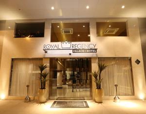 a lobby of a building with two potted plants at Royal Regency Palace Hotel in Rio de Janeiro