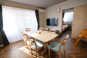 a dining room with a table and chairs and a bedroom at Yasuragi-KAWAGOE 1F in Kawagoe